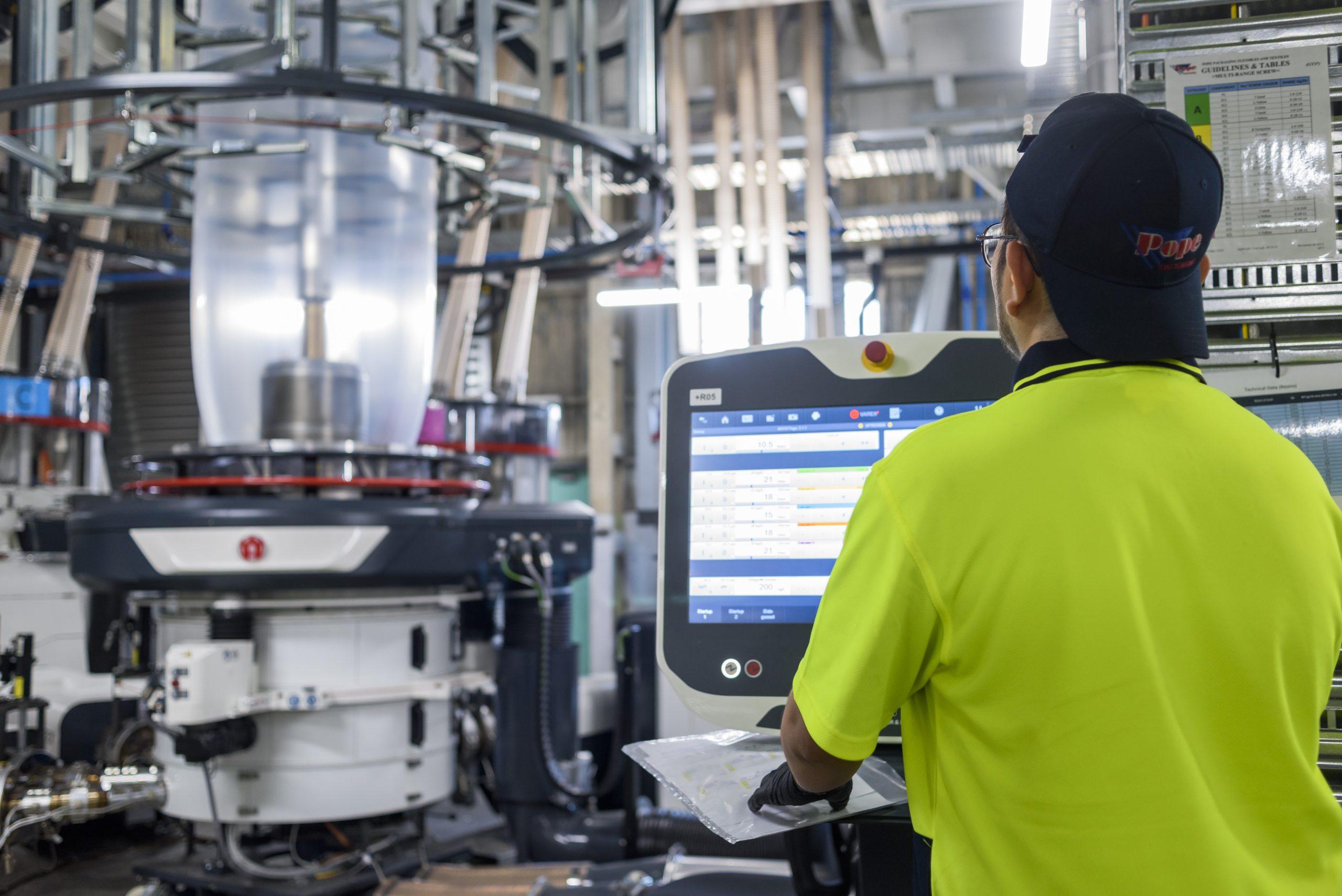 Worker running the blown film machine.