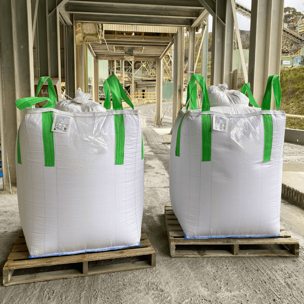 Two heavy-duty FIBCs on a construction site.