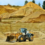 Bulldozer in a sand quarry representing the mining and minerals industry