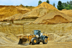 Bulldozer in a sand quarry representing the mining and minerals industry