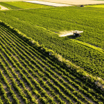 Aerial view of crops being treated, showing safe and efficient fertiliser & chemical packaging.