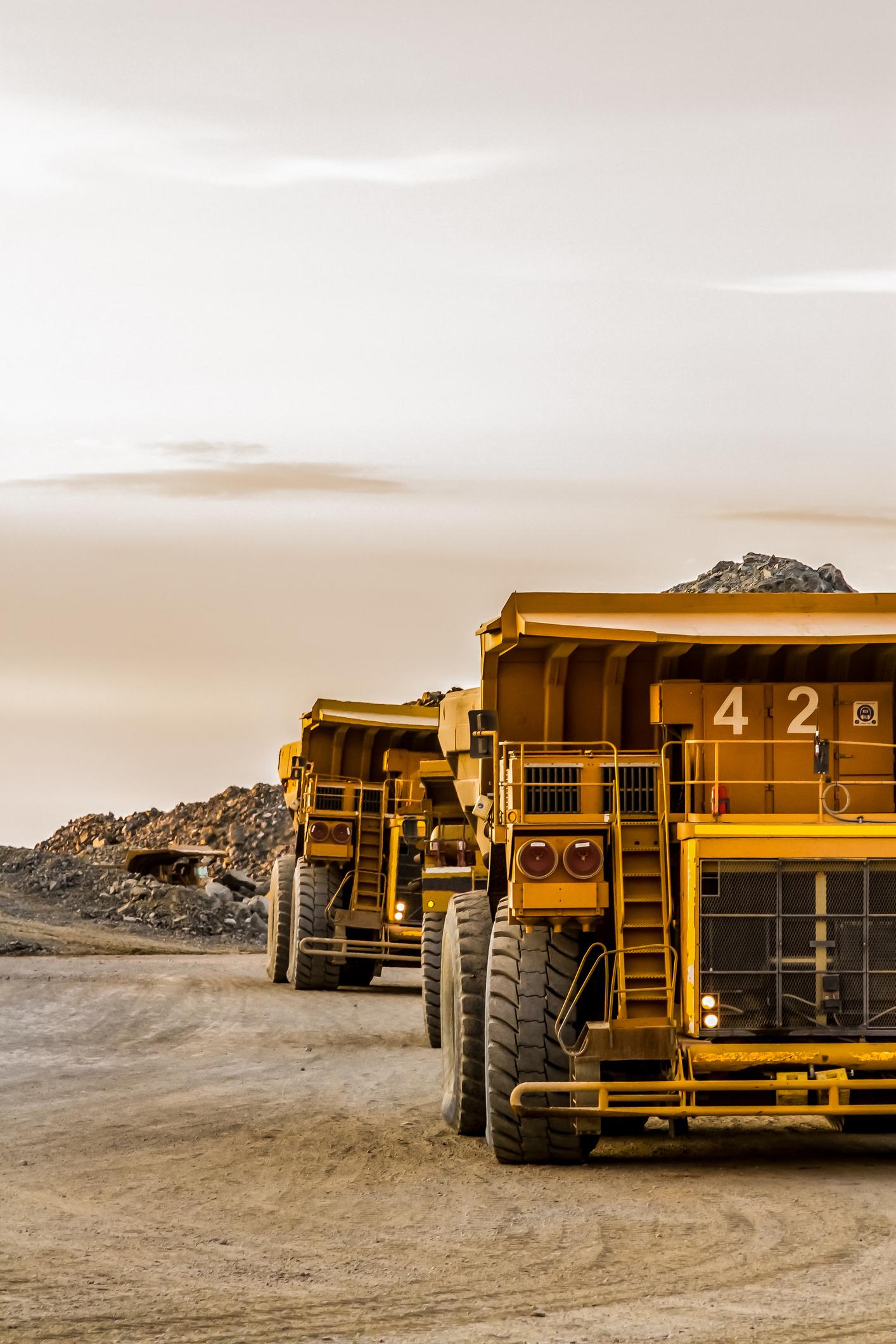 Dumper trucks operating in dusty quarry conditions using reliable mining packaging solutions.