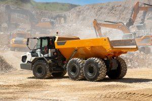 Dumper truck in quarry supporting heavy-duty manufacturing packaging for industrial, dry conditions.