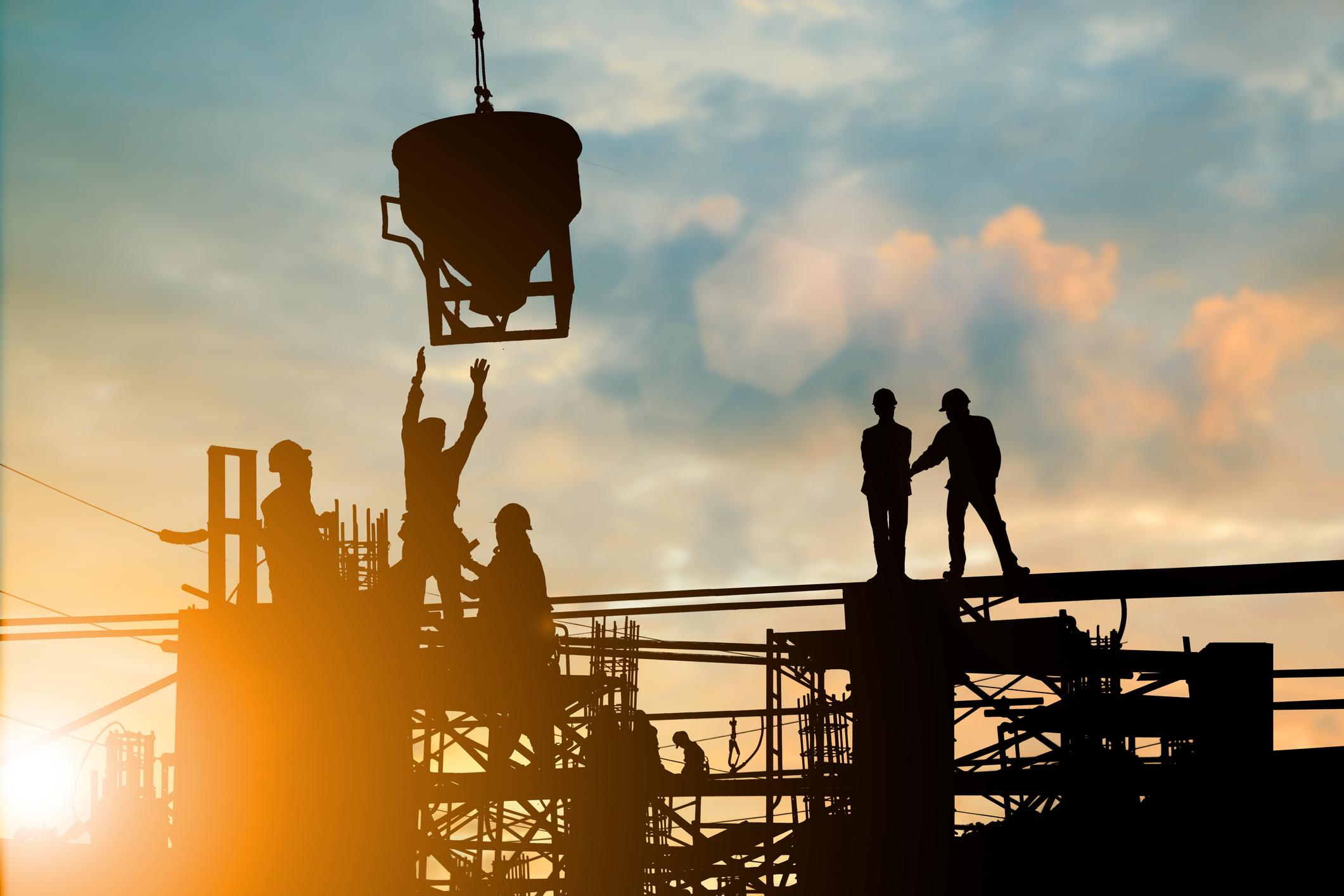 Silhouette of engineer and construction team working at site over blurred background sunset pastel for industry background with Light fair.Create from multiple reference images together.