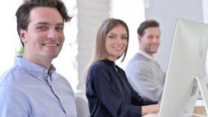 Internal sales and admin team sitting at their computers.