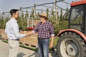 Territory manager Northern California worker chats to customer on farm.