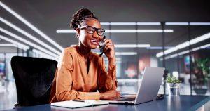 Sales Coordinator answering the phone at her desk.